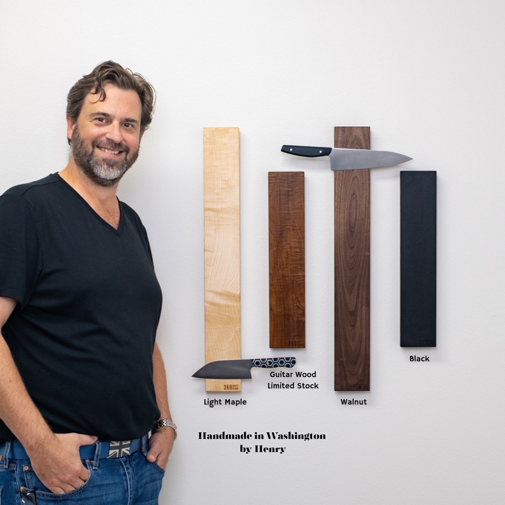 Henry beside the handmade BAR collection in light maple, guitar wood, walnut and black